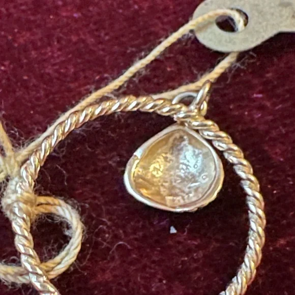 14 karat yellow gold cable ring with a beautiful shell hanging